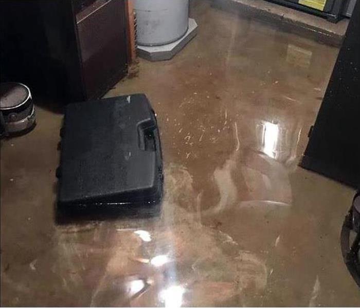 A tool box on standing water. Water damage in a house.